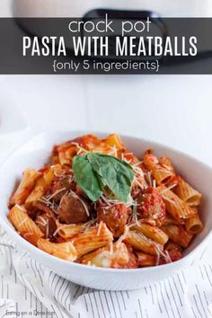 a white bowl filled with pasta and meatballs