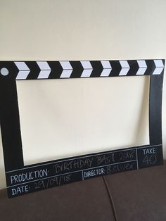 a black and white photo frame with the words production written in chalk on it's sides