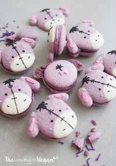 small pink and white decorated cookies with black stitches on the eyes, ears and nose