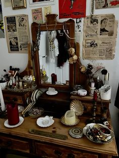 an old dresser has many items on it and is covered with papers, pictures, and other things