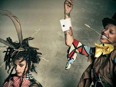 two women with weird hair and scarves on their heads are posing for the camera