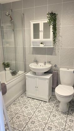 a bathroom with a toilet, sink and bathtub