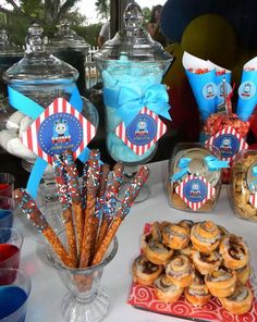 a table topped with lots of donuts and candy