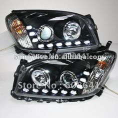 the front end of a pair of black and chrome head lights with white leds