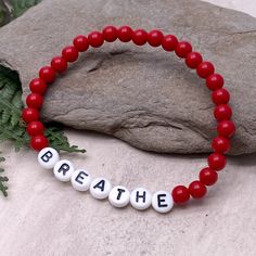 BREATHE Acrylic Bead Bracelet - the perfect mix of style and motivation, this bracelet features a simple yet inspiring design to remind you to take a moment to breathe. Available in a variety of colors, choose the one that speaks to you. The custom made bracelet has 6mm acrylic beads and flat white acrylic letter beads, which are 7mm diameter. It is thread on strong elastic and will stretch a little bit so you can roll it onto your wrist gently. Allergy friendly, lightweight and super comfortabl Inspirational Stretch Bracelet With 8mm Round Beads, Inspirational 8mm Beads Stretch Bracelet, Casual Hypoallergenic Beaded Bracelet For Everyday, Inspirational Hypoallergenic Stretch Bracelet With Round Beads, Casual Healing Friendship Bracelets With 8mm Beads, Casual Stretch Bracelet With Round Beads For Meditation, Casual Beaded Stretch Bracelet For Meditation, Casual Red Beaded Bracelets, Take A Moment To Breathe