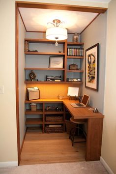 a room with a desk and shelves in it