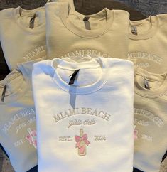 four white shirts with pink bows on the front and one has a name tag that says miami beach junior club