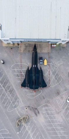 an aerial view of a fighter jet parked on the tarmac