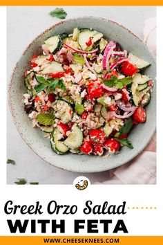 greek salad with feta and cucumbers in a bowl on a white table