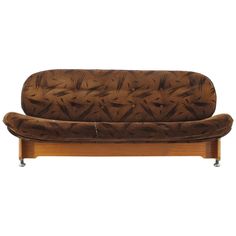 a brown couch sitting on top of a wooden frame