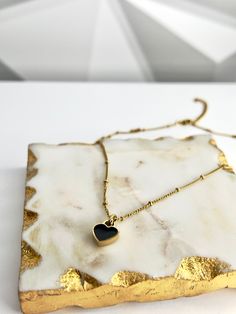 Our Double-sided Heart Necklace, made from 18k gold-plated stainless steel, is sure to make a bold and stylish statement. The timeless color combination of white and black is perfect for any occasion, whether you’re dressing up or down. Wear it with your favorite outfit and let your heart shine! 💖 Features: 18k Gold Plated High-Quality Stainless Steel Tarnish Free Trendy Gold Plated Heart Charm Necklace, Trendy Gold Plated Heart Necklace With Heart Charm, Trendy Gold Plated Heart Necklace, Modern Gold Necklace With Black Enamel, Black Heart Pendant Necklace With Clavicle Chain, Chic Heart-shaped Necklace For Gift, Trendy Black Heart-shaped Necklace, Trendy Gold Jewelry With Heart Print, Black Heart Pendant Necklace With Adjustable Chain