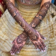 two hands with henna tattoos on them