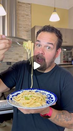 a man is holding a plate of spaghetti and looking surprised