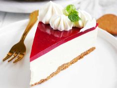 a piece of pie with whipped cream and raspberry topping on a white plate