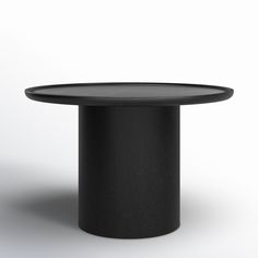 a black round table sitting on top of a white floor