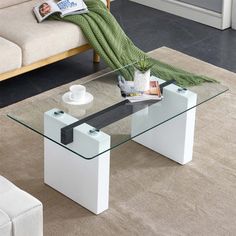 a glass coffee table sitting on top of a rug