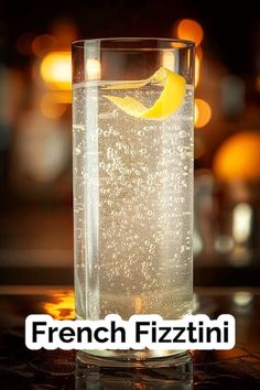 a tall glass filled with water and lemon wedged in it's side, next to the words french fizzitini