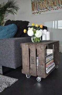 a living room with a couch, coffee table and flower arrangement on the end table