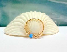 Fire Blue Opal 2mm Cartilage Ring Gold by HelenCollectionJewel Conch Piercing Aesthetic, Hoop Conch Piercing, Aesthetic Fish, Conch Ring, Piercing Aesthetic, Jewelry Nose Rings, Conch Hoop, Piercings Ear, Fire Blue