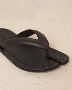 Tabi thongs by Maison Margiela in black. Elegant and minimal flip-flops crafted in durable polyurethane. Featuring Maison Margiela's heritage classic Tabi split-toe, inspired by the traditional 15th century Japanese sock bearing the same name - launched for the Maison's debut collection in 1989. Polyurethane Upper, Polyurethane Sole.Made in Italy. Tabi Slippers, Flip Flop Craft, Wishlist 2024, 15th Century, Split, Product Launch, Italy