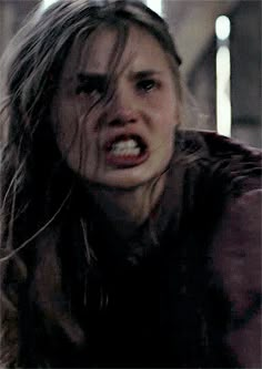 a woman with her mouth open in the middle of a scene from an action movie