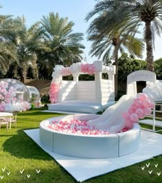 an inflatable pool is decorated with pink and white balloons