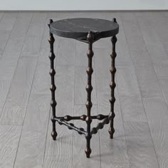 a small black table sitting on top of a hard wood floor