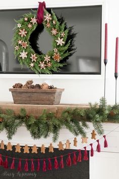 a christmas wreath is hanging on the mantle