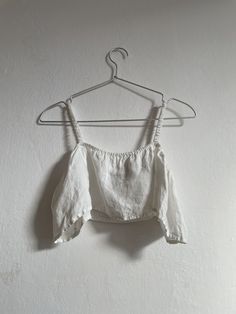 Discover our handmade linen crop top, crafted with care in a small studio in Poland. Made from 100% vintage linen fabric, this crop top combines timeless style with sustainable fashion. Perfect for adding a touch of boho chic to your wardrobe, it features elastic straps for a comfortable and adjustable fit. Key Features: Handmade Quality: Sewn with precision in a small studio in Poland, ensuring a unique and high-quality product. Premium Fabric: Crafted from 100% vintage linen, offering a lightw Fitted Linen Casual Crop Top, Casual Fitted Linen Crop Top, White Bohemian Ramie Tops, Summer Cropped Linen Tops, Cropped Linen Top For Summer, White Cotton Crop Top With Cropped Hem, Linen Crop Top For Summer Vacation, Cropped Linen Crop Top For Beach, Fitted Linen Crop Top