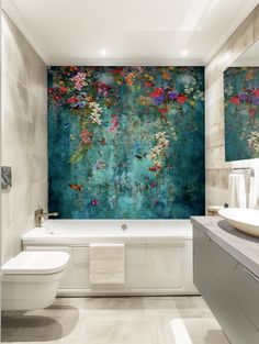 a bathroom with a large painting on the wall next to a bathtub and toilet