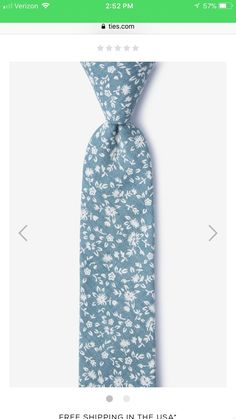 a blue tie with white flowers on it and the words free shipping in the usa