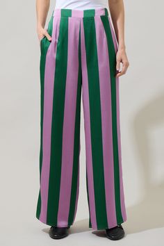 The Rag Stripped Wide Leg Pants are retro-chic and ready for summer! A stripped pattern with elastic waistband hugs the waist, while sitting high. The pant legs open up to create the perfect wide leg fit. Style them with the matching top and a cami tank. - Elastic waist- High waisted- Wide leg- Flowy- Color: Green MultiSize + Fit - Model is 5'8" and wearing size XS- Measurements taken from size S - Waist: 28 1/2" - Inseam: 29 1/4" Fabric Self: 100% Polyester, Lining: 97% Polyester 3% Spandex Sty Flowy Pants Pattern, Stripe Pants Outfit, Stripped Pattern, Cute Disney Outfits, Striped Wide Leg Pants, Purple Pants, Retro Clothing, Flowy Pants, Pants Pattern