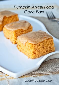 three pieces of cake sitting on top of a white plate with a fork next to it