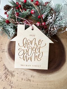 a wooden ornament with the words home sweet home on it