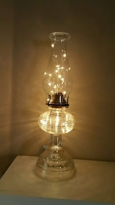 Oil Lamp With Fairy Lights, Oil Lamp Repurposed, Oil Lamp Christmas Decor, Antique Lanterns Decor Ideas, Repurposed Oil Lamps, Oil Lantern Decor Ideas, Vintage Oil Lamp Decor Ideas, Old Lamps Repurposed, Kerosene Lamp Decor