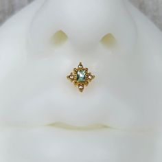 a close up view of a ring on top of a white mannequin's head