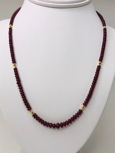 This strand of fine quality spinel beads would be at home in a 19th century ballroom or a 21st century boardroom! Rich, pomegranate red oval rondelles have been hand strung with 22k yellow gold spacers and an 18k yellow gold clasp in an elegant 19-inch strand. I have never seen red spinel beads before! Spinels have often been mistaken for fine rubies throughout history and looking at this strand, it is easy to see why. The beads, graduating in size from 3.00 to 6.50 millimeters, are of the fines Elegant Ruby Necklace With Polished Beads, Formal Ruby Necklaces With Round Beads, Formal Rondelle Beaded Necklaces With Gemstone Beads, Formal Rondelle Gemstone Beaded Necklaces, Elegant Faceted Oval Bead Necklaces, Yellow Gold Ruby Bead Jewelry, Formal Ruby Gemstone Beads Jewelry, Elegant Hand-strung Rondelle Beaded Necklaces, Classic Rondelle Faceted Beads Jewelry