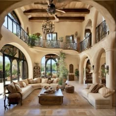 a living room filled with furniture and lots of windows