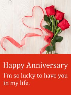 a bouquet of roses on a table with the words happy anniversary i'm so lucky to have you in my life