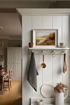 a kitchen with white walls and wooden floors