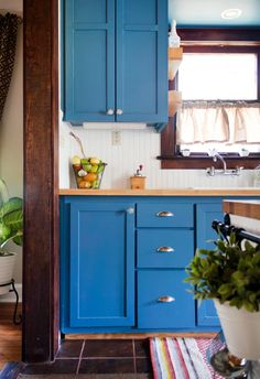 a kitchen with blue cabinets and a yellow arrow pointing to the right