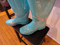 a pair of blue boots sitting on top of a stool