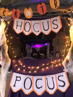 the trunk of a car decorated with halloween decorations and lights for hoccus pocus