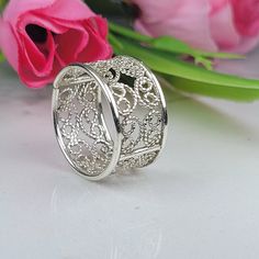 Filigree ring made in the filigree technique by intricate metal work, creating a rich floral and delicat look. The wide silver band is inspired by boho jewelry combined with modern design. This boho art ring is perfect for a beloved woman, and as a pampering gift for yourself. The structure of the ring is approximately 10 mm wide, creating an elegant and unique style. The ring is very flattering to the finger, comfortable to wear as a jewel for everyday use and impressive as a jewel for a special occasion. he ring is made of 925 sterling silver by hand tools only. Each piece of jewelry is handmade to order, therefor due to the special nature of handcrafting, there may be slight differences compared to the jewelry in the photos shown. This adds to the charm and individuality of each piece, Wide Silver Band, Wide Silver Ring, Chunky Silver Rings, Art Nouveau Earring, Art Ring, Silver Heart Ring, Filigree Jewelry, Fine Art Jewelry, Wide Ring