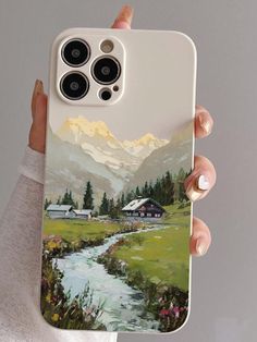 a person holding up a phone case with a painting on it