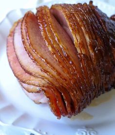 sliced ham sitting on top of a white plate