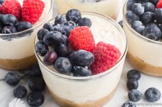 three desserts with berries and yogurt in them