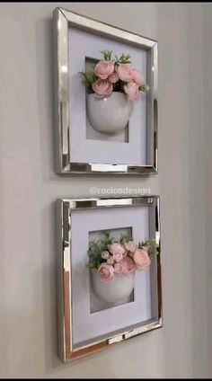 two framed pictures with flowers in them hanging on the wall