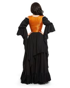 the back of a woman wearing an orange and black dress with ruffles on it