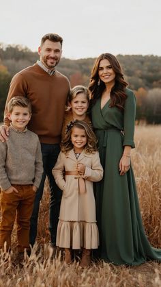 a family posing for a photo in a field